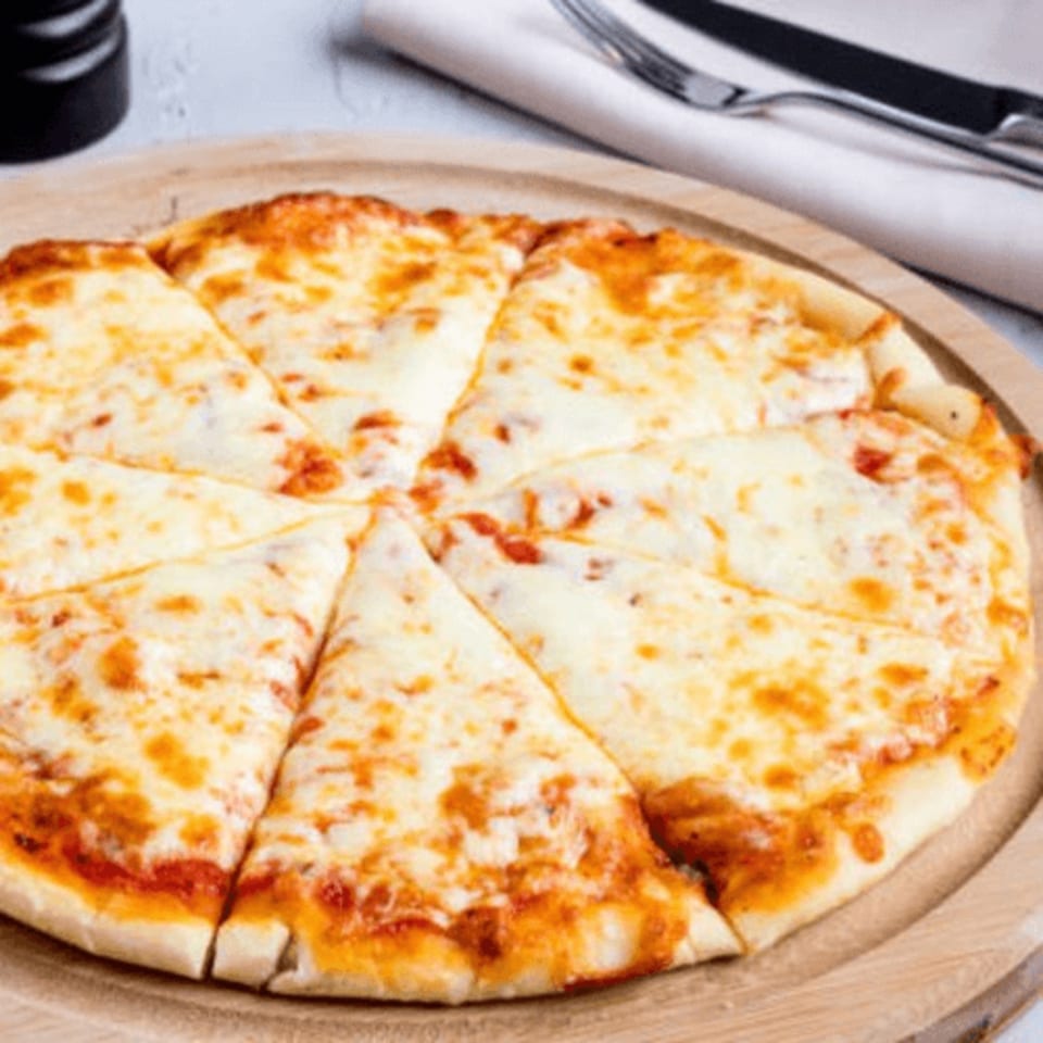 A Flicks cheese pizza, cut into eight slices, on a wooden serving board.